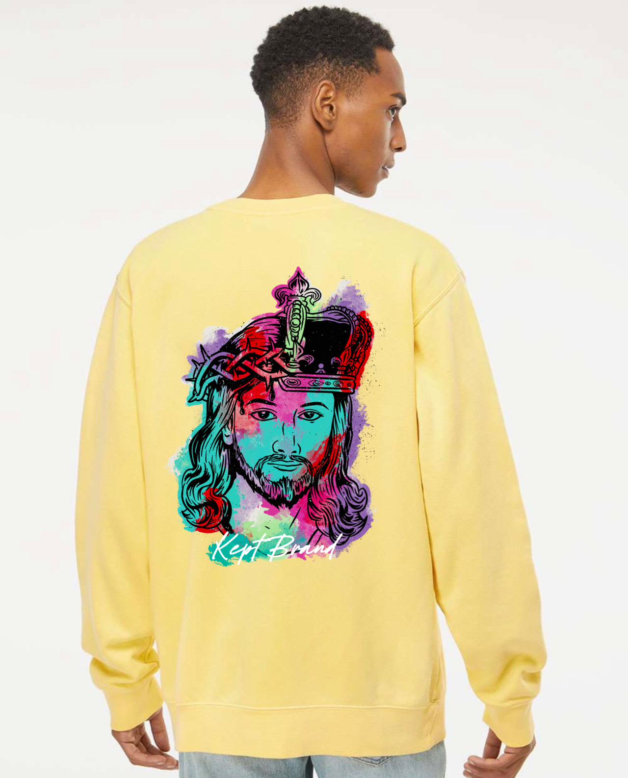 A man wearing a yellow sweatshirt with an image of Christ on it.